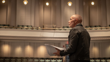 Film composer Michael Abels listens to a rehearsal with Cornell Wind Symphony in Bailey Hall.