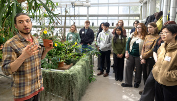 A tour group in the Liberty Hyde Bailey greenhouse