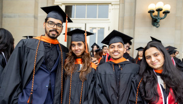 Students posing in front of Goldwin Smith Hall. 