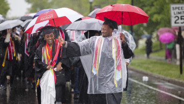 Students processing in the rain. 