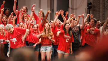 Reunion 2026 attendees raise their hands in celebration