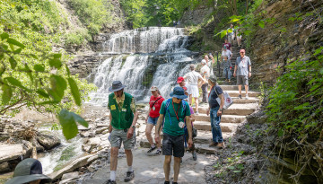 Reunion 2026 attendees hike along a waterfall