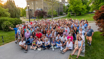A large group of reunion attendees pose outside
