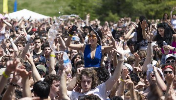 A cheering crowd and a stream of water from a thrown bottle. 