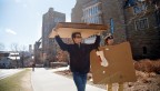 Students carrying boxes in front of law school