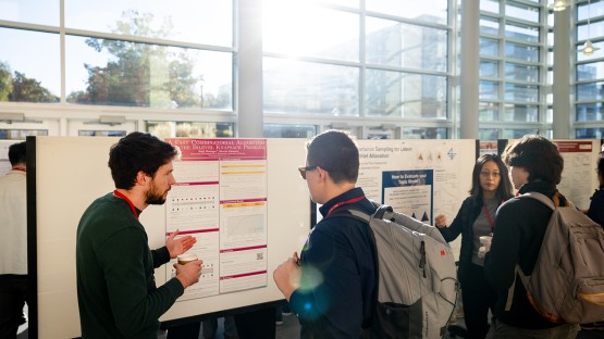 ORIE students gather for a poster session in Statler Hall.